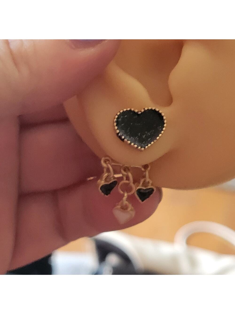 Glittery gold and black dangling heart post earrings